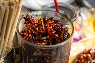 Glass with marinated red dried chilies