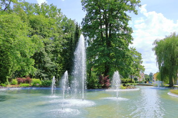 Iron fountain in the middle of the lake, water splash
