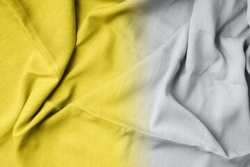 Yellow fabric texture background. Top View of cloth textile surface. Abstract backdrop for design. Demonstrating trendy Color of the Year 2021. Illuminating Yellow and Ultimate Gray. Duotone