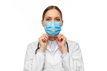 medicine, profession and healthcare concept - female doctor in white coat with stethoscope wearing medical mask