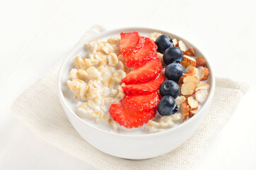 Oatmeal porridge with strawberry, blueberries and nuts