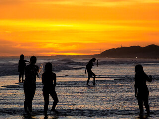 Silhouettes in the sunset at the beach