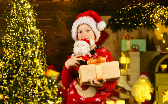 Real happiness. Child happy excited near christmas tree. Merry christmas. Happy childhood concept. Kid wear santa hat and christmas sweater. Santa brought me gifts. December tradition. Sale discount