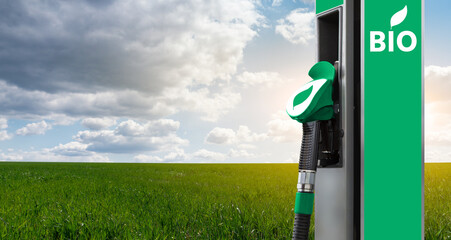 Biofuel filling station on a background of green field and blue sky