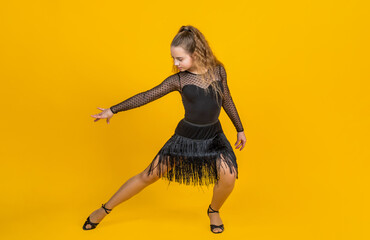life in motion. child in dance pose. professional slowfox and quickstep. waltz and tango. dancewear fashion clothes. dancing school. teen girl ballroom dancer. kid dancing in black dress