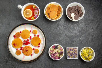 top view yummy pancakes with cup of tea on the dark background sweet pie dessert cake