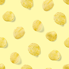Seamless pattern made from Potato chips on yellow background flat lay. potato snack chips isolated Fast food banner.