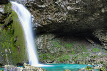 Beautiful waterfall falling from a rock covered by moss. Kot waterfall, San Leonardo, Cividale del Friuli, Udine province, Friuli Venezia Giulia region, Italy. Valli del Natisone nature.