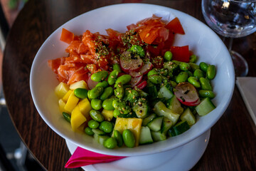 Salmon poke with avocado and mango, seaweed, pickled carrots, cucumber