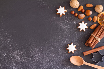 Obraz na płótnie Canvas Christmas background with flour, cookies, nuts and spices