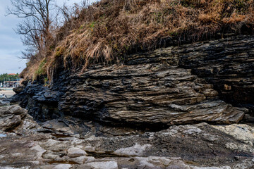 Ocean cliff of stratified geological rocks