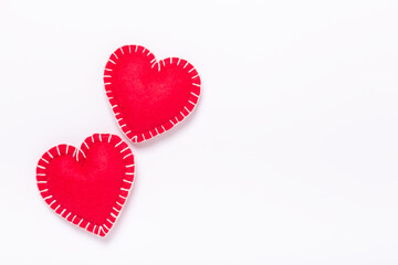 Two red textile hearts on white background. The concept of Valentine Day. Copy space for your text