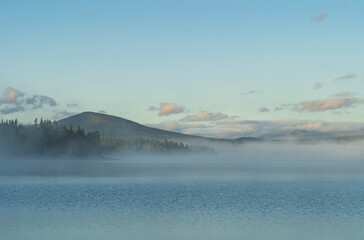 Fog over a lake in Sweden during a summers morning.