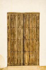 Old wooden door with rusty screws