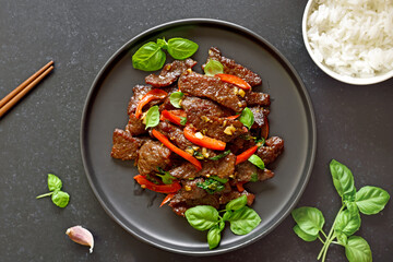 Thai beef stir-fry with pepper and basil on plate
