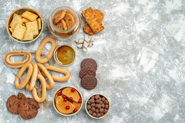 Fototapeta na wymiar Above view of variety of sweeties with fruits cookies biscuits and honey on blue backgrounds