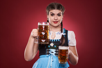 Young woman in traditional costume holding beer