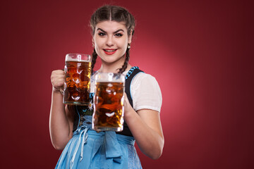 Young woman in traditional costume holding beer