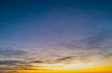 Naklejka na ściany i meble bright orange and blue sky with cirrus clouds at sunrise