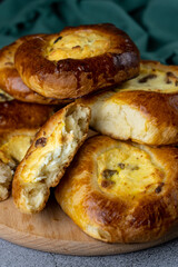 Traditional Russian baking pastry vatrushka, round buns, curd tart selective focus, closeup. Cheesecake with cottage cheese. Rustic food Photography.