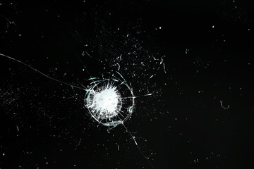 cracks on black glass background, broken abstract glass hole destruction concept