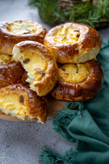 Traditional Russian baking pastry vatrushka, round buns, curd tart selective focus, closeup....