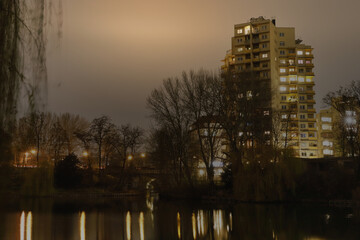 Fototapeta na wymiar Lietzensee Park with adjacent buildings in the Berlin capital district of Charlottenburg on a winter December evening.