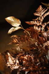 The leaves of the trees and paportonica in the decorations are gilded with expensive gold and bronze paint. Holidays decoration.