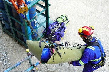 Sked stretches encapsulate injured workers to take off scaffolding in working at heights and transfer them to the field medical team as part of emergency drills at a chemical plant oil and gas factory