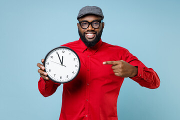 Smiling young bearded african american man 20s wearing casual red shirt eyeglasses cap standing...