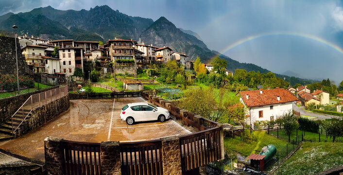 Panorama of the village of Poffabro, one of the most beautiful villages in Italy, with the rainbow on background after the storm, in the Friulian Dolomites natural park