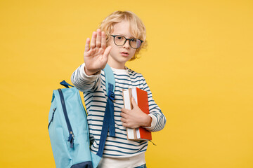 Serious little male kid teen boy 10s in striped sweatshirt eyeglasses backpack hold school books...
