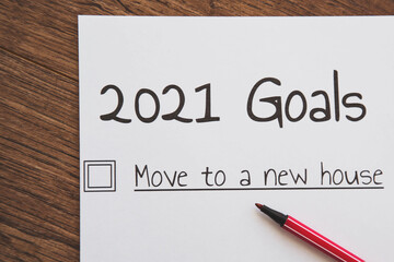 planner of goals and plans for 2021, a sheet of paper with the inscription move to a new house from to do list with a tick 