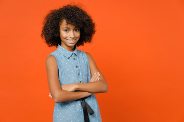 Smiling little african american kid girl 12-13 years old in casual denim dress holding hands...