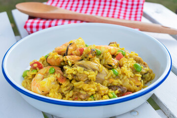 Top view of Paella spanish food with seafood, mussels, shrimps, chicken and rice with saffron mediterrnean dish.