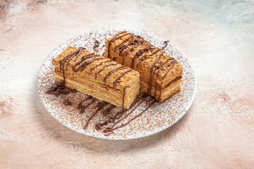 front view yummy cake slices with choco icing on light background biscuit cake sweet