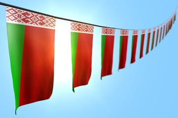 pretty many Belarus flags or banners hanging diagonal on rope on blue sky background with bokeh - any celebration flag 3d illustration..