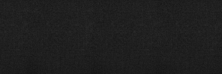 Black abstract background. Black fabric texture background. Wide banner.