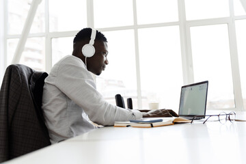 Attractive young dark-skinned businessman in office