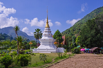 Beautiful white pagoda in the valley with blue sky background