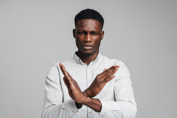 Displeased young african american man in white shirt