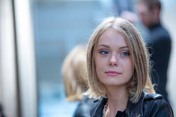 Close up portrait of a pensive and daydreaming beautiful blonde woman. Selective focus