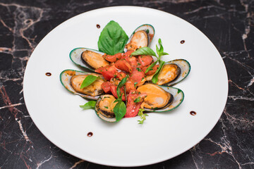 Mussels in pink sauce with white wine on a white plate
