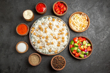 Top view of peas and rice meal sauerkraut salad mayonnaise spices and ketchup on dark table