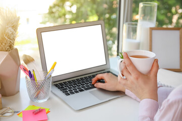 Young woman working on modern laptop in office
