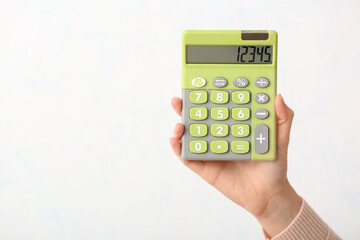 Female hand with calculator on white background