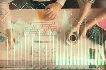 Double exposure of man and woman working together and financial chart hologram drawing. market...