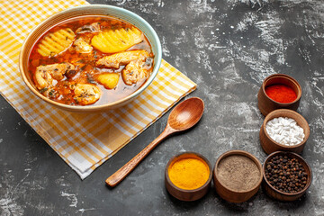Side view of mouth-watering chicken soup five various spices and spoon
