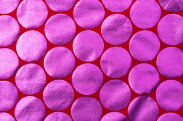 Texture of red fabric with pink foil circles