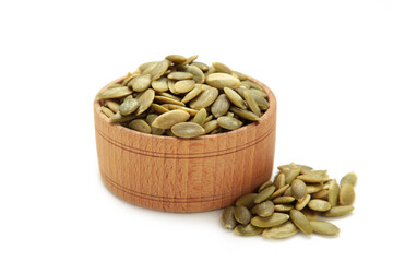 Pumpkin seed in bamboo bowl isolated on white